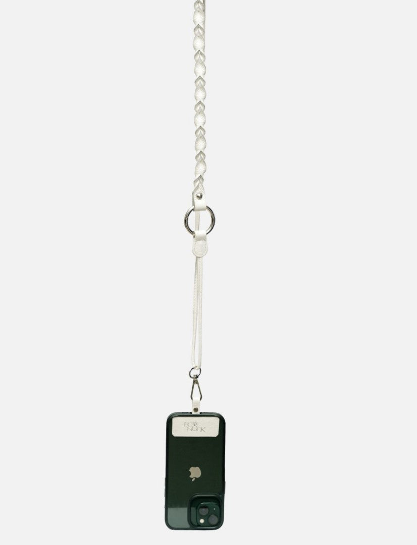 Black iPhone attached to an ivory white braided leather sling with metal ring and clasp on white background