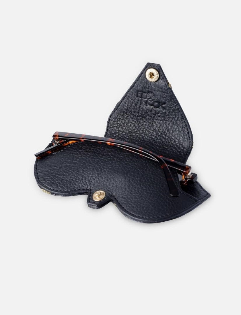 Black textured leather sunglass case open with tortoiseshell sunglasses inside on white background