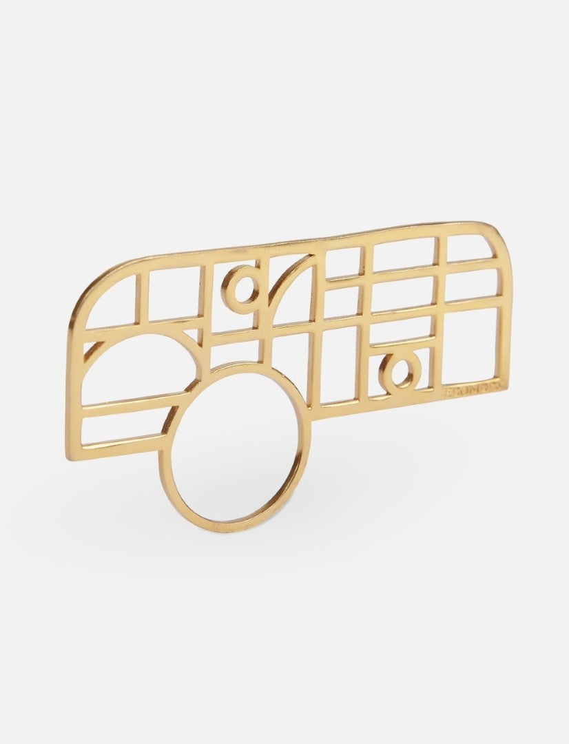 gold metal ring with an abstract geometric grid design on white background