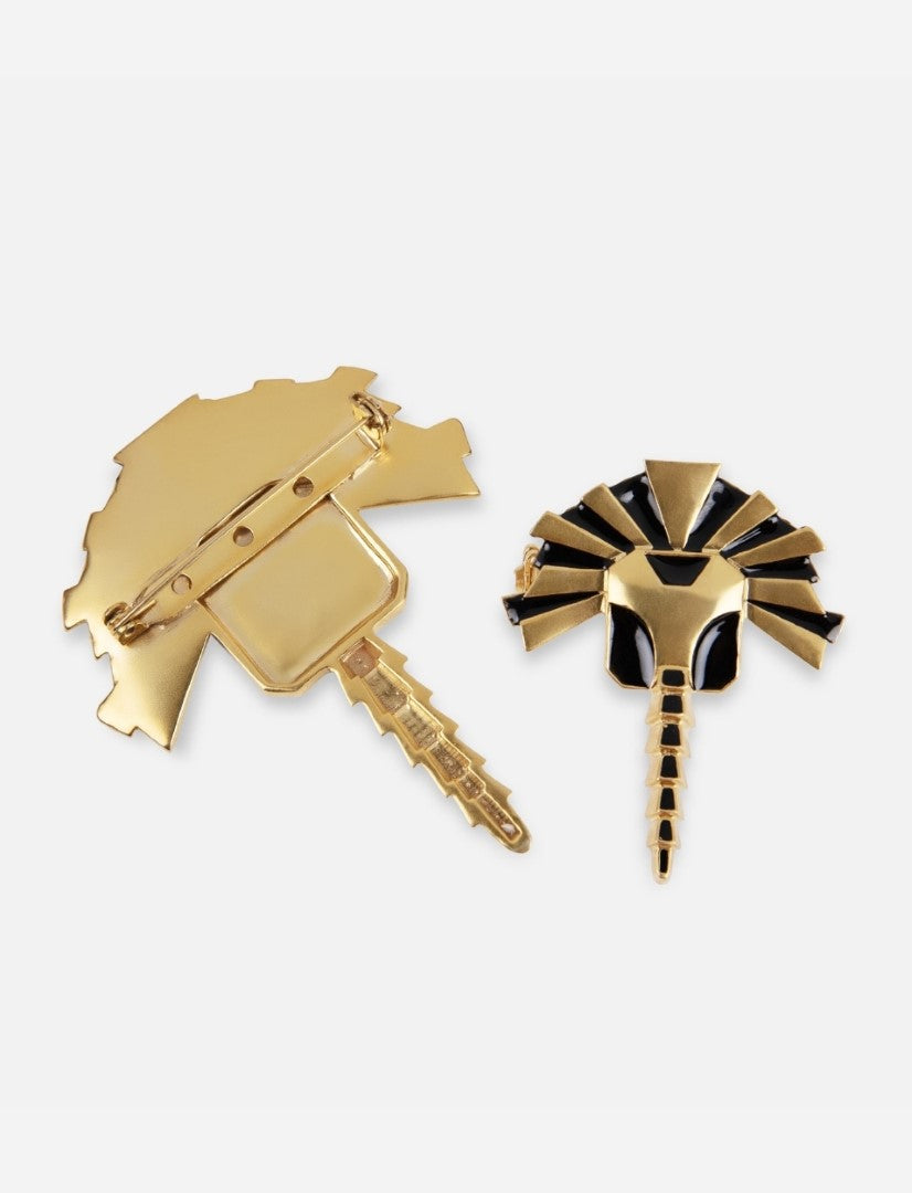 Gold and black enamel metal brooch with pin fastening, handcrafted design resembling a stylized insect or bird