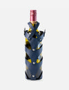 Wine bottle with metallic blue leather stitched case and silver rivets on white background