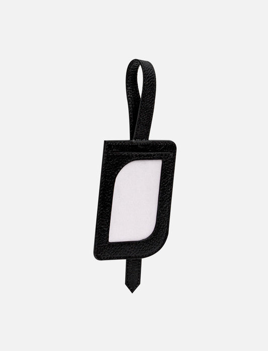 Black leather luggage tag with loop and clear ID window isolated on white background