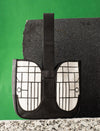 Black and white leather handbag with grid pattern, displayed on textured stone surfaces with green background