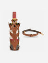 Tan leather wine bottle carrier with stitched straps and detachable crossbody strap on white background