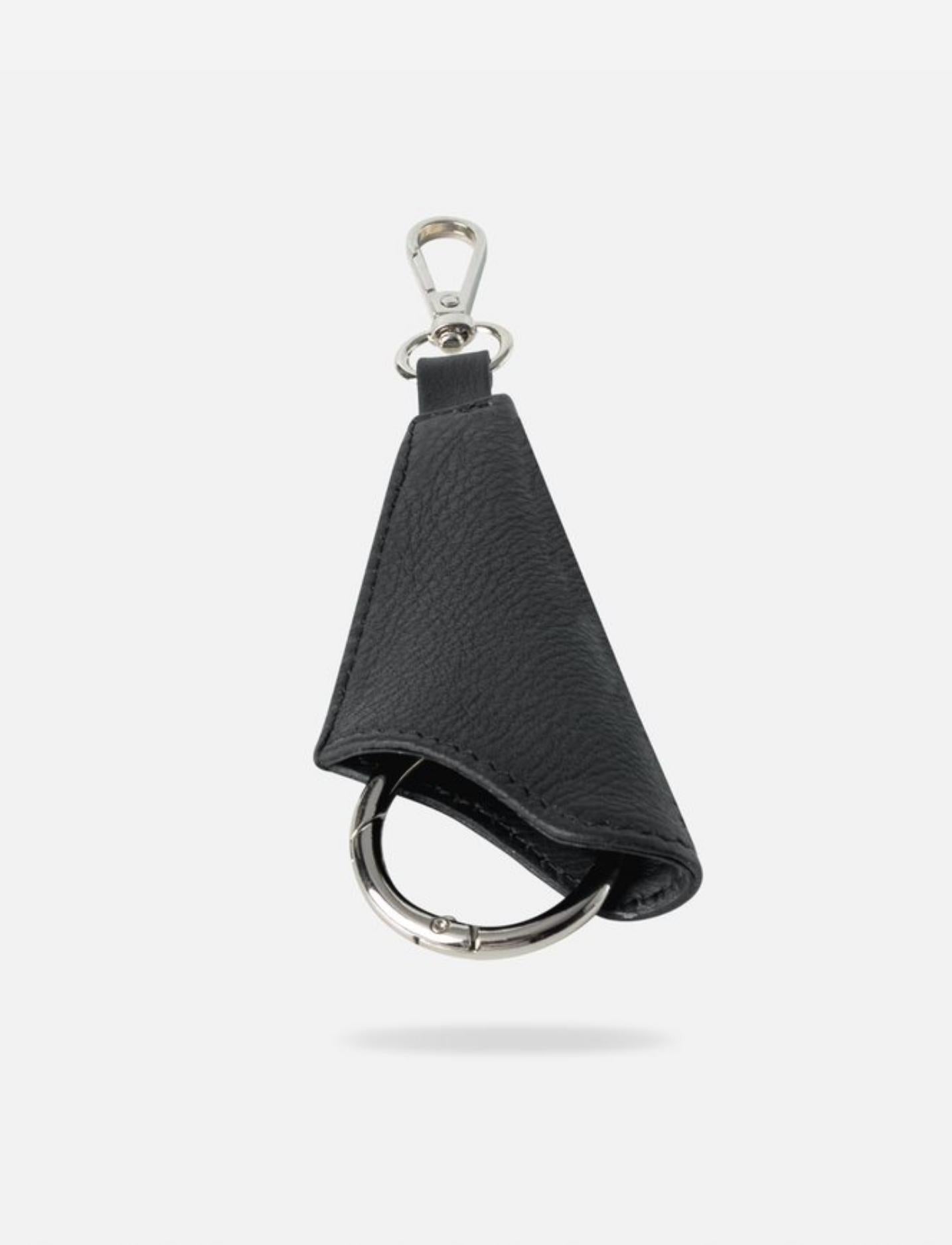 Black upcycled leather keychain with silver attachment loop and metal clip on white background