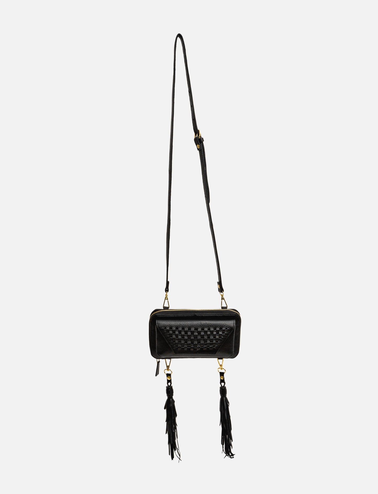 Black leather crossbody bag with woven front detail and two long tassels on white background
