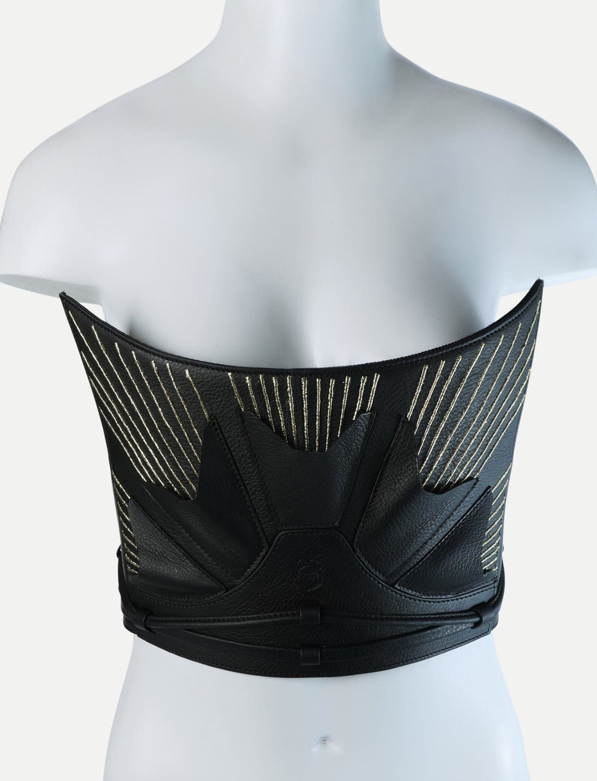 Black leather corset with gold embroidery and leaf-like design on mannequin torso