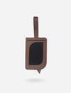 Timeless tan upcycled leather luggage tag with clear ID window and stitched strap on white background