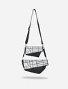 Two black and white crossbody bags with geometric patterns and detachable straps on white background