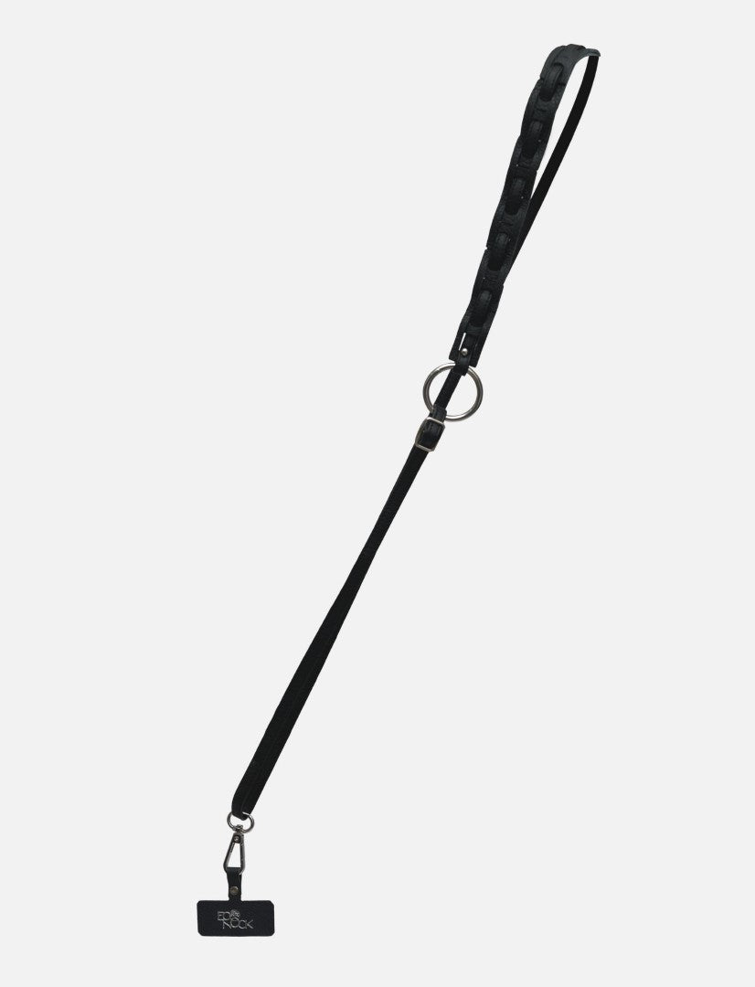 Timeless black leather phone sling with upcycled lanyard and metal ring clasp on white background