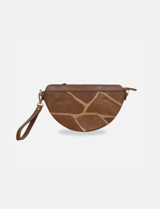 Timeless tan half-moon leather sling bag with gold stitch pattern and wrist strap on white background