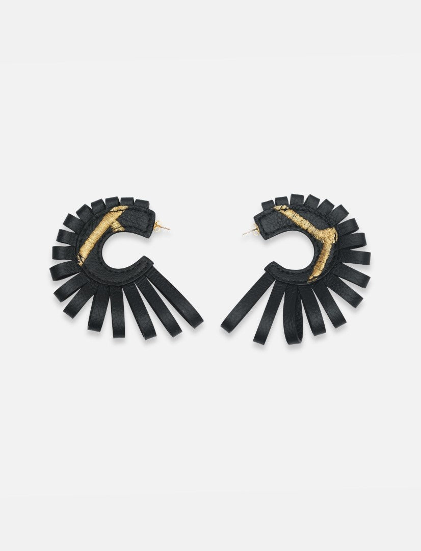 Pair of black leather hoop earrings with gold thread detail and fringe design on white background