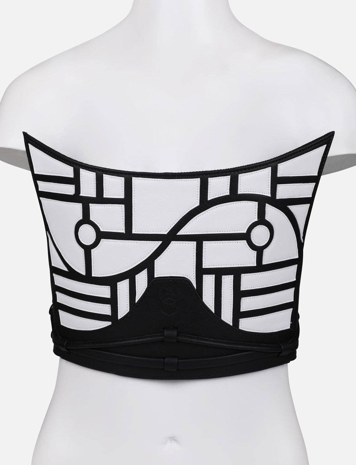 Back view of black and white upcycled leather corset with geometric applique on mannequin