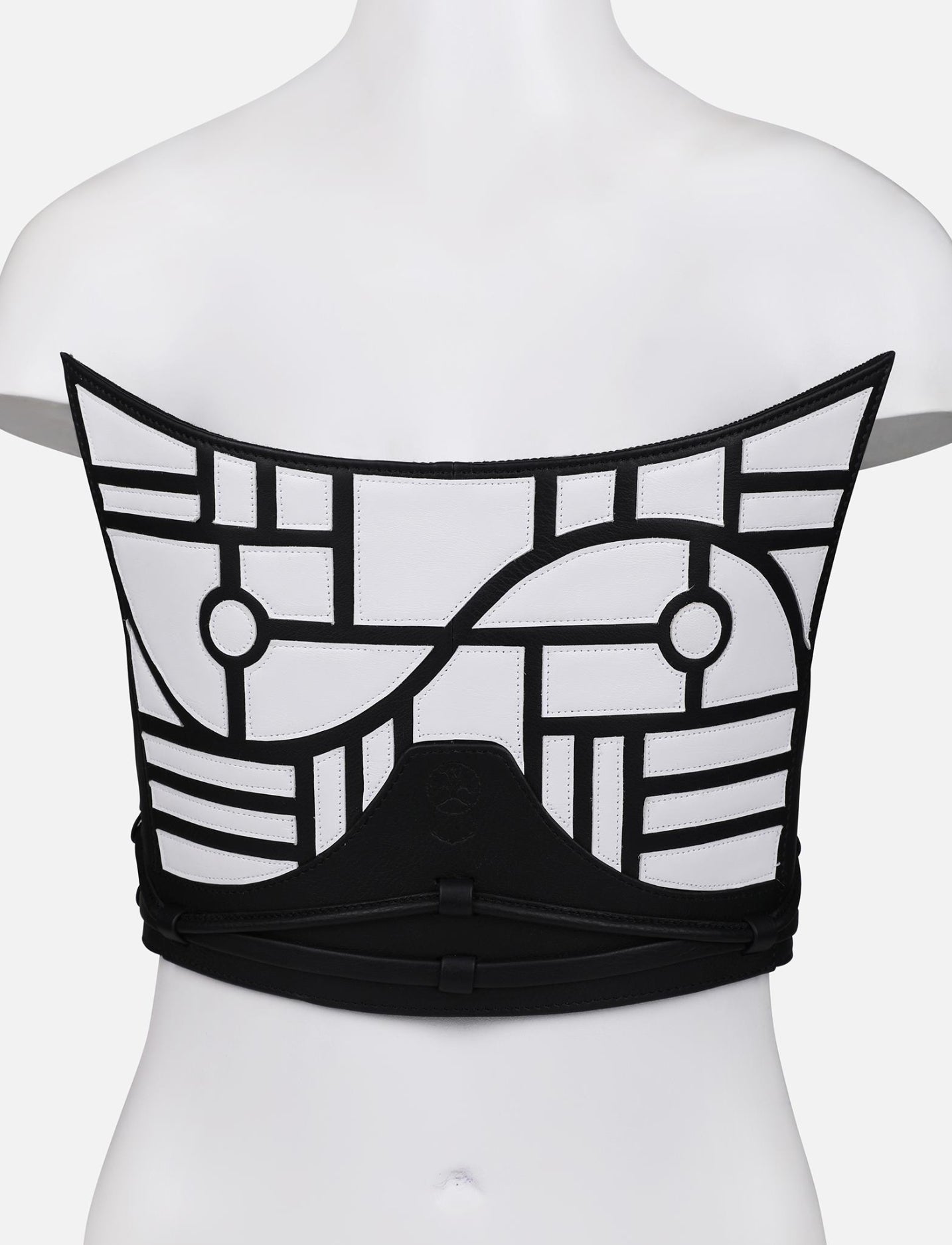 Back view of black and white upcycled leather corset with geometric applique on mannequin