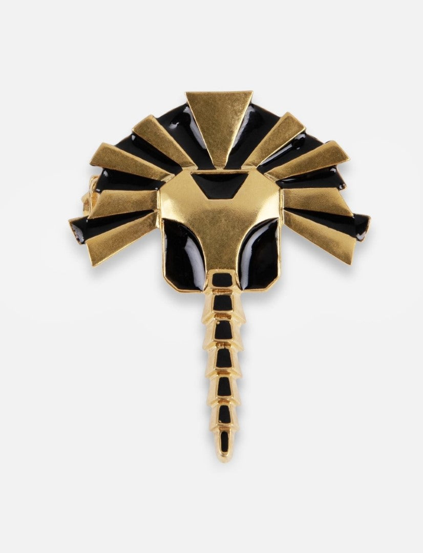 Gold and black enamel metal brooch shaped like a stylized scorpion with geometric patterns