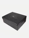 Black textured rectangular gift box with embossed gold logo on lid, white background