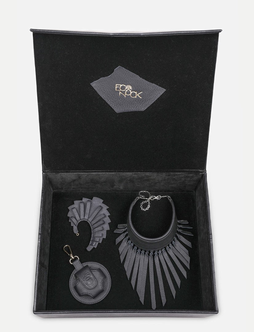 Open black gift box containing upcycled black leather jewelry and accessories by Econock