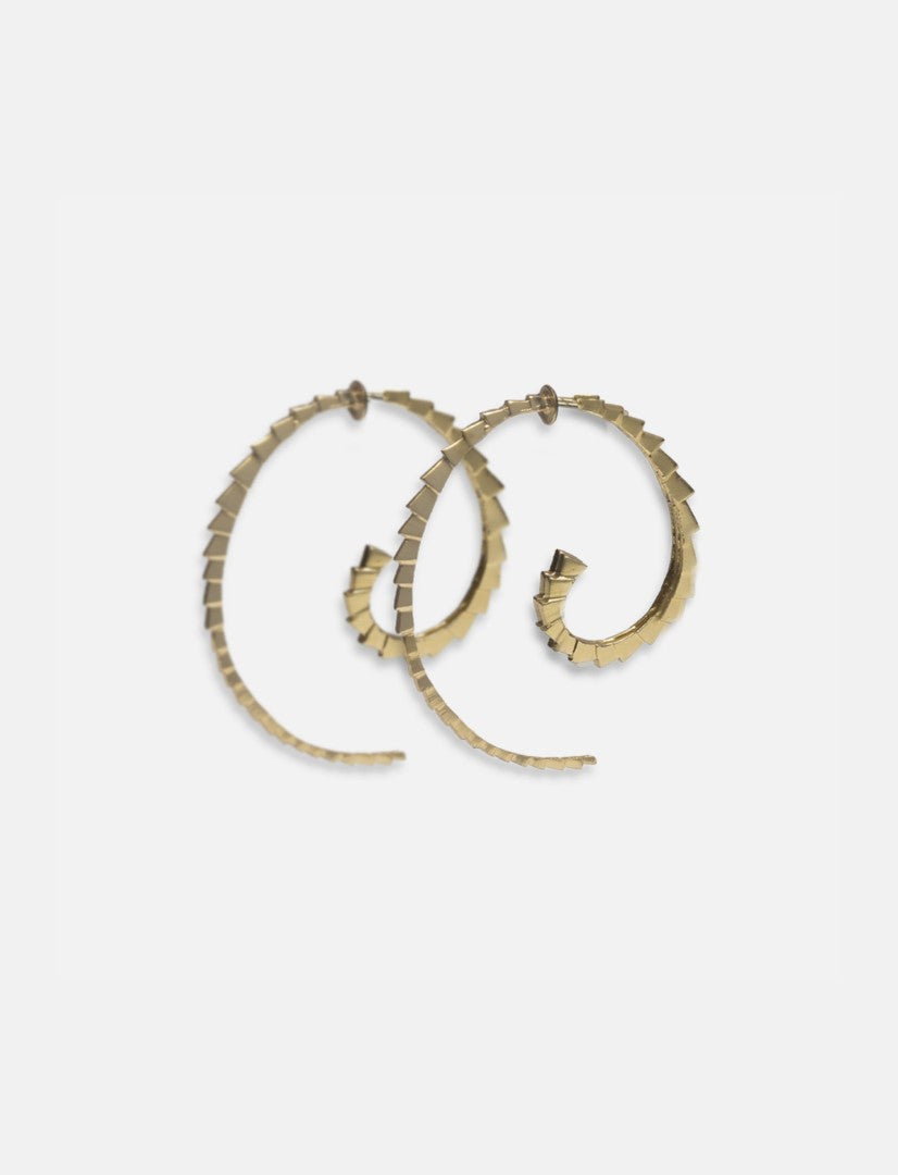Handcrafted Tuscon Lord gold spiral hoop earrings with textured square pattern on white background