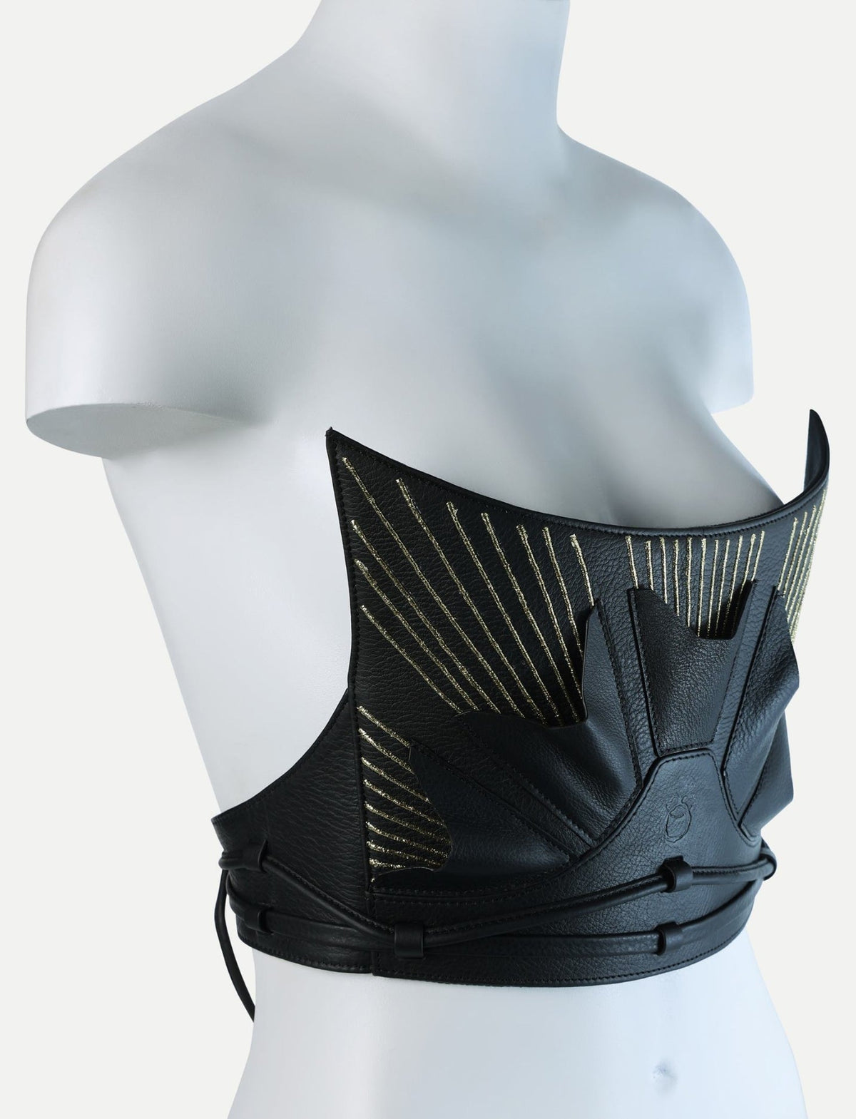 Black leather corset with gold embroidered sunburst design on white mannequin bust