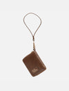 Timeless tan leather gender-neutral wallet with wrist strap and gold zipper on white background