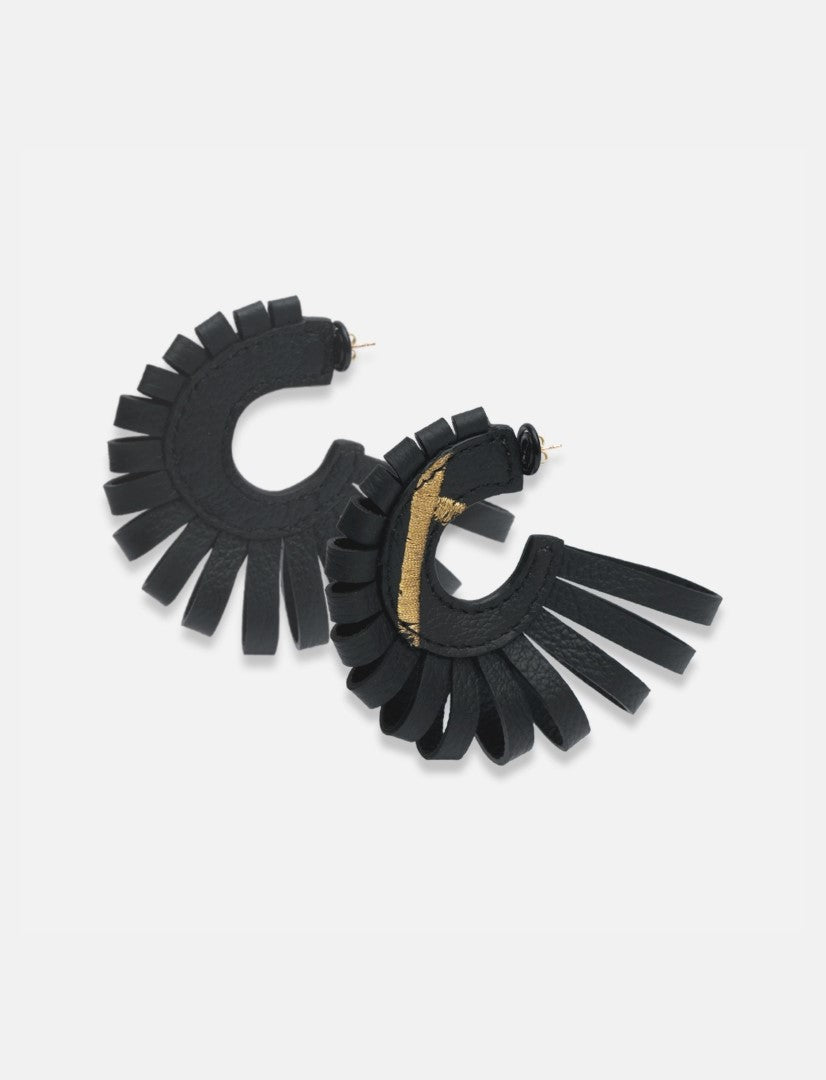 Handcrafted black leather hoop earrings with fringe and subtle gold accent on white background