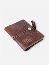 Handcrafted tan leather passport cover with woven detail and EcoNook logo