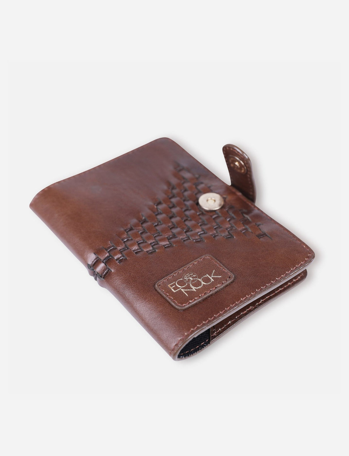 Handcrafted tan leather passport cover with woven detail and EcoNook logo