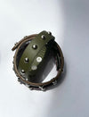 Green and brown leather bracelets with silver stud embellishments on white background