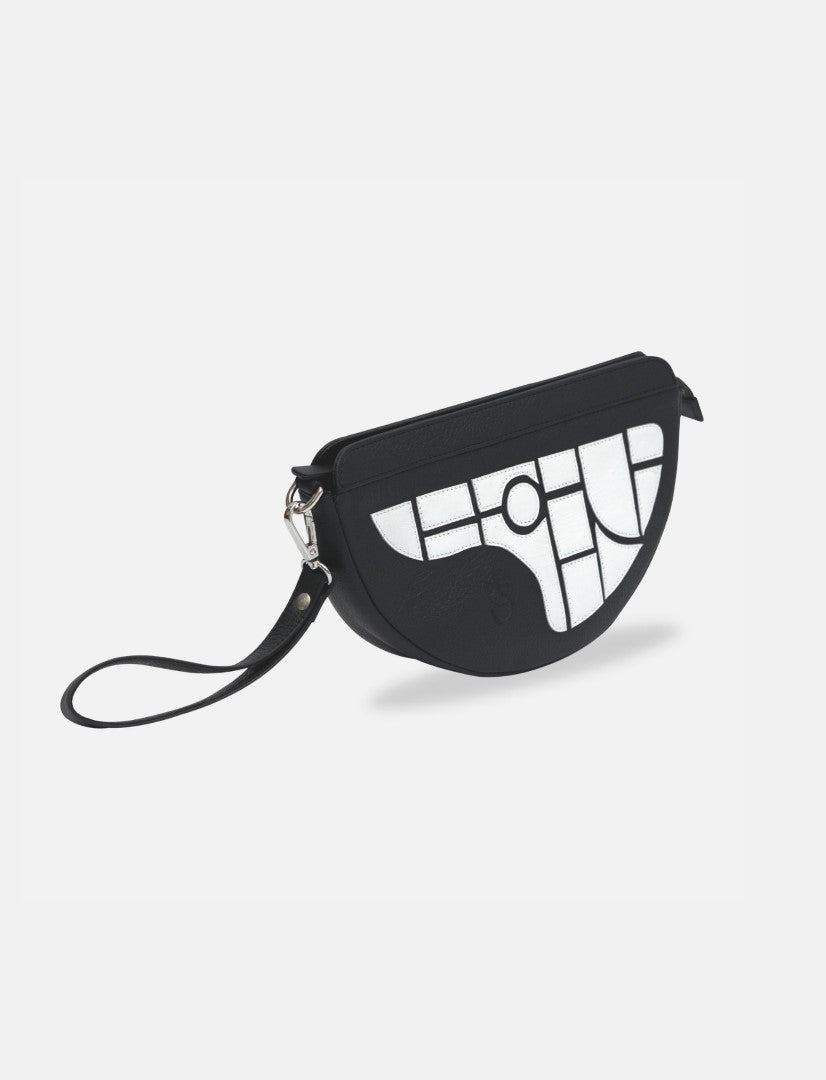 Black half-moon cllutch with sling bag with white geometric pattern and black leather wrist strap on white background