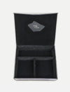 Open black velvet organizer box with three compartments and logo patch inside the lid