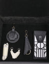 Black and white leather accessories set in black velvet box with tree emblem details