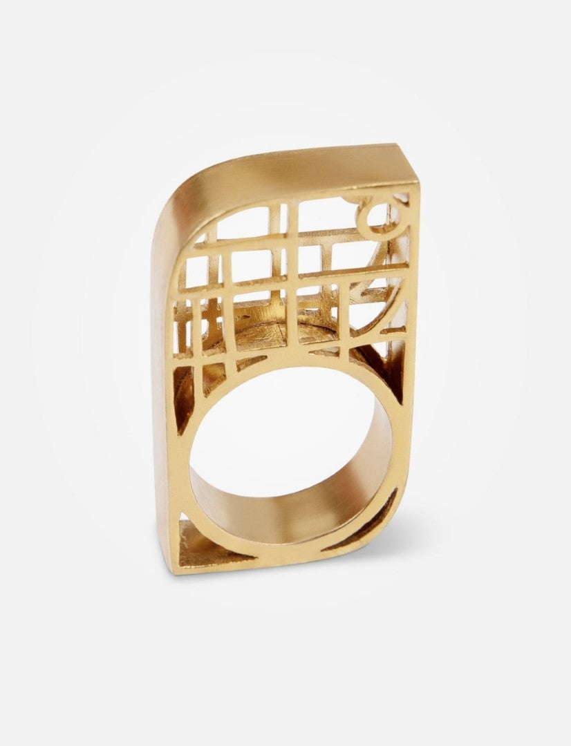 Modern geometric gold ring with open lattice design on white background