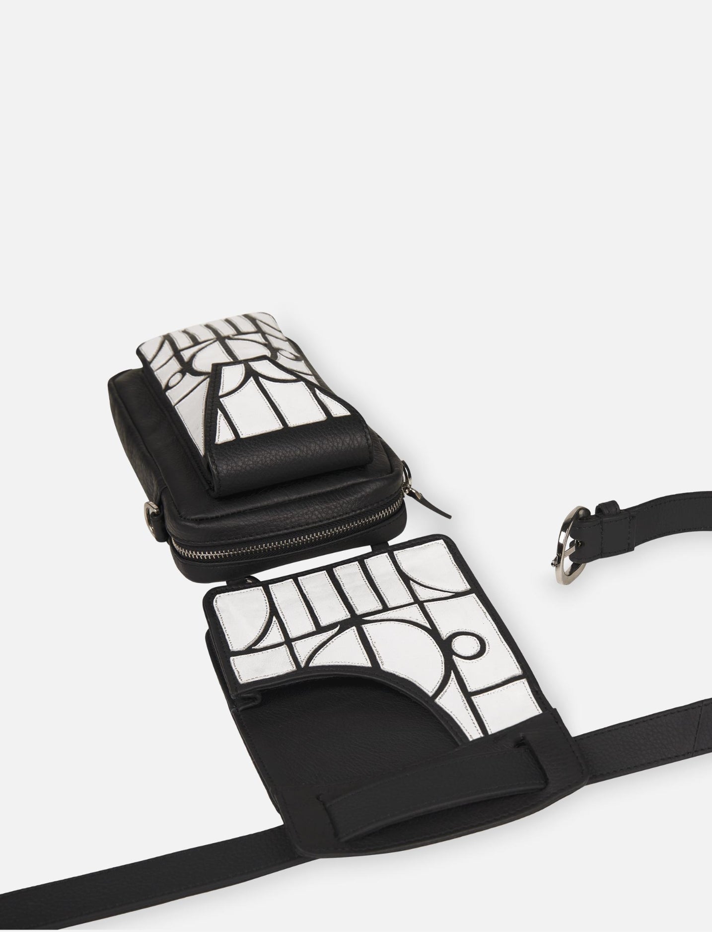 black leather thigh bag with white geometric applique and detachable waist belt on white background
