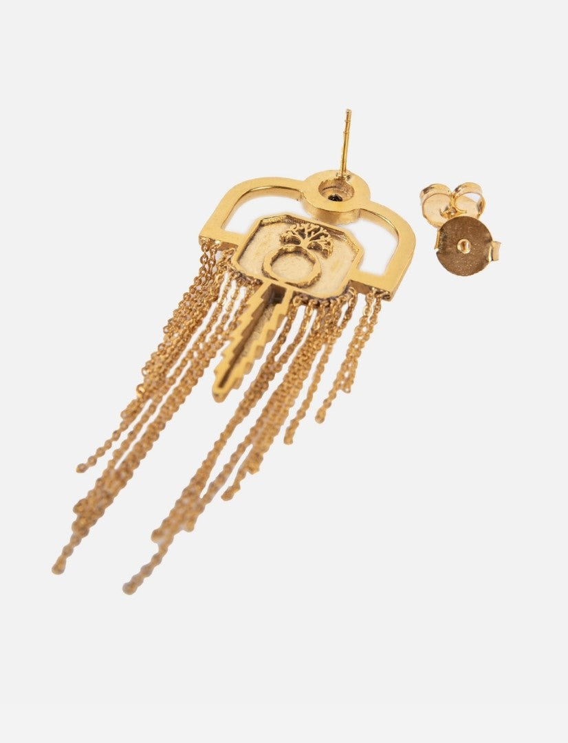 Gold-tone key-shaped earring with chain tassels and post back on white background