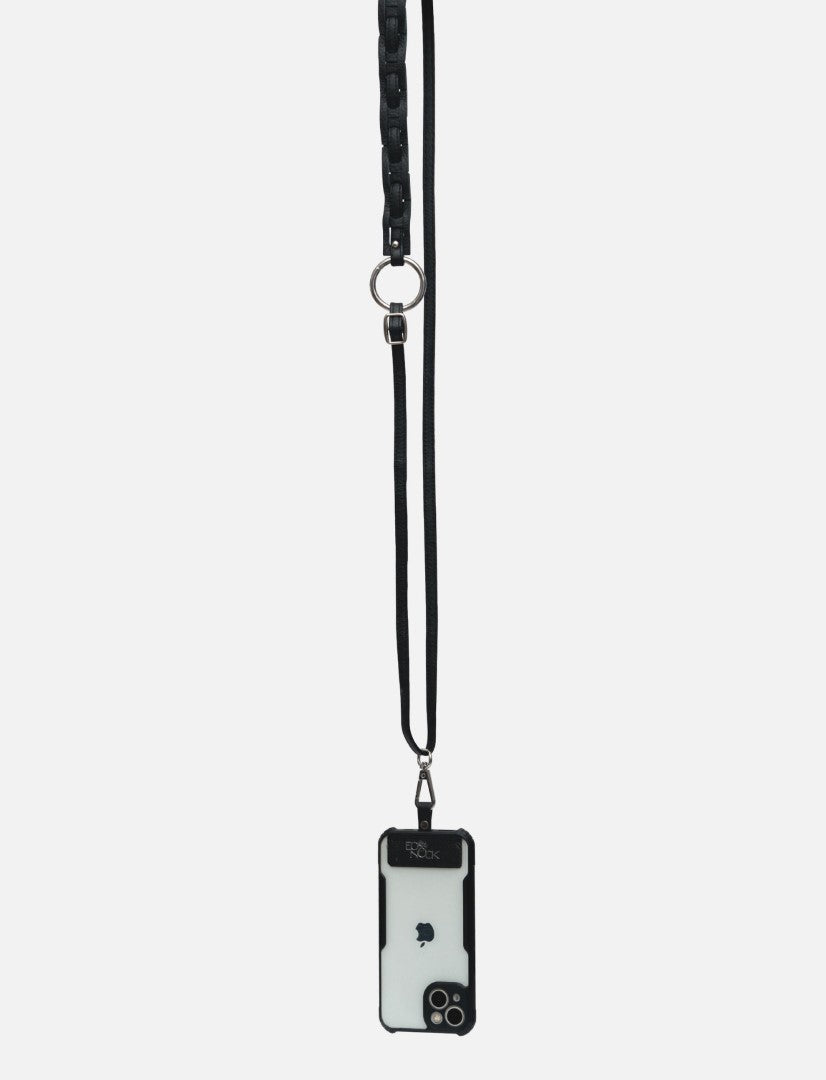 Black leather phone sling with silver ring and black iPhone case hanging on white background