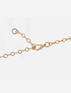 Close-up of gold chain necklace with round links and a lobster clasp fastener on white background