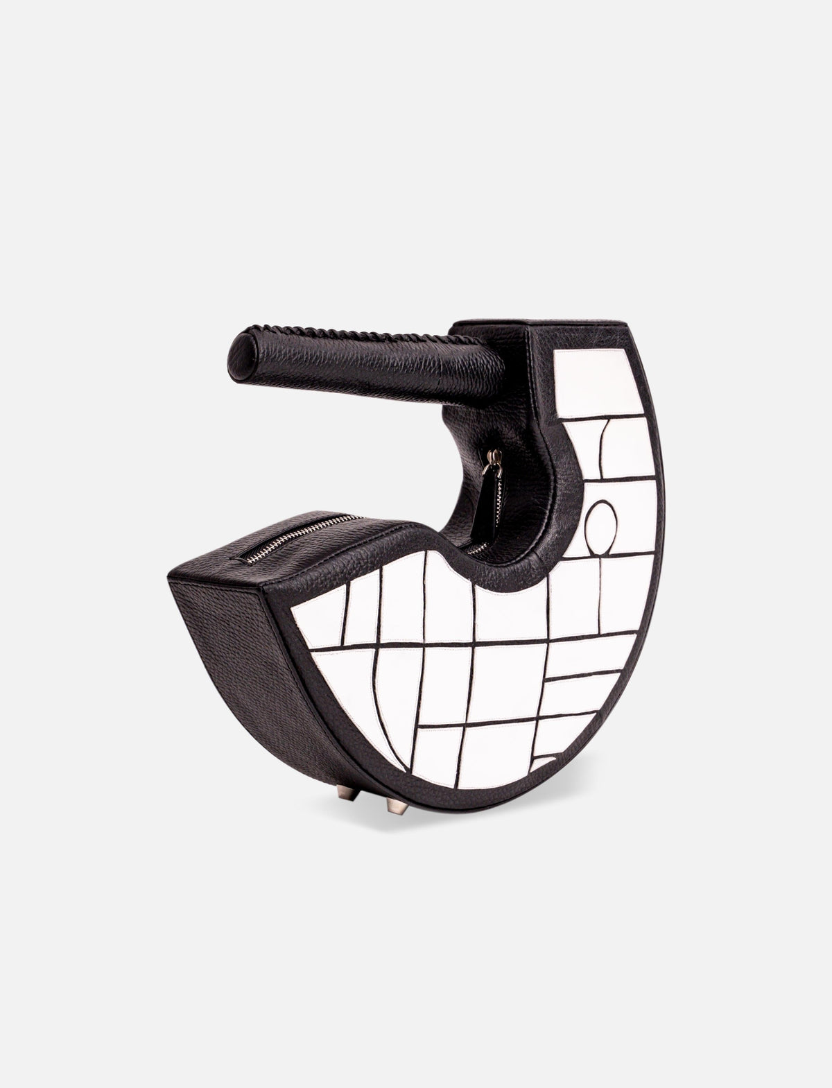Black and white crescent-shaped handbag with geometric grid pattern and textured handle