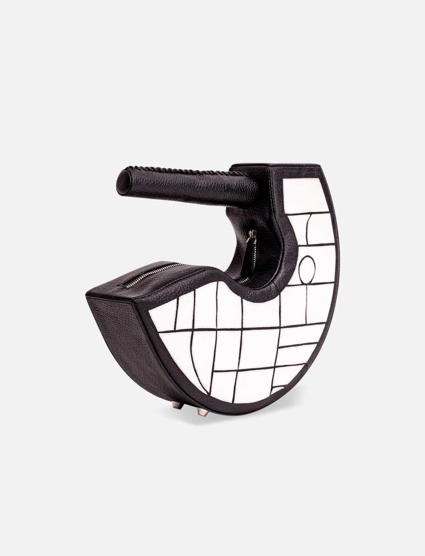 Black and white crescent-shaped handbag with geometric grid pattern and textured handle