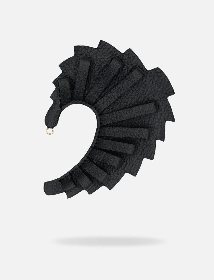 Black upcycled leather hand-crafted ear cuff with layered textured design on white background