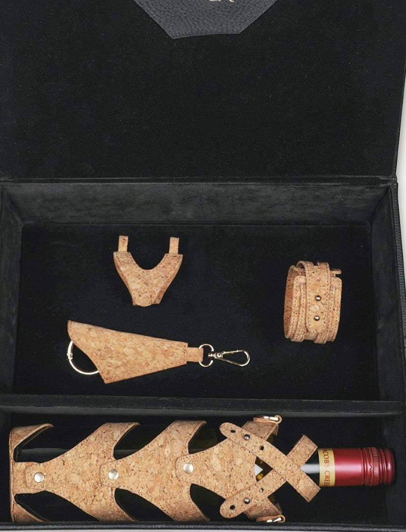 Black gift box containing cork wine bottle holder, cork keychain, cork bracelet, and cork mini bag
