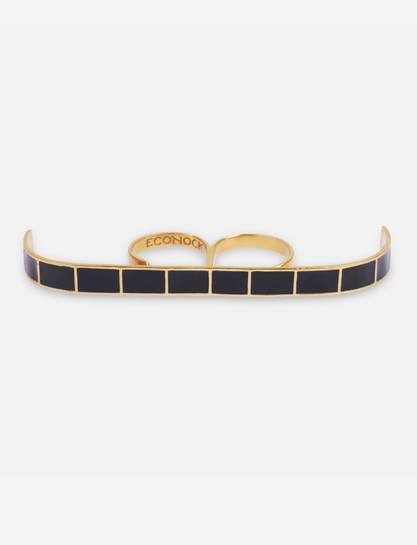 Gold metal multifinger ring with rectangular black enamel inlays and two connected finger bands on white background
