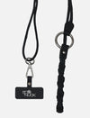 Black leather phone sling lanyard and braided keychain with metallic ring on white background