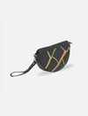 Black leather sling bag with gold crack pattern and wrist strap on white background