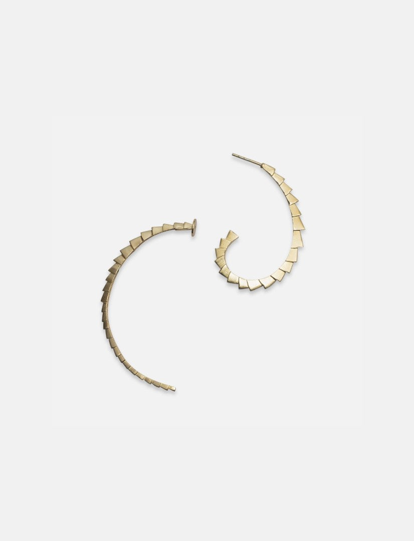 Handcrafted gold-tone crescent hoop earrings with geometric square details on white background
