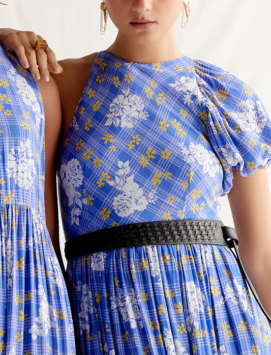 Close-up of blue floral plaid dress with puff sleeve and black woven belt on model