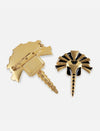 Gold and black enamel metal brooch with pin fastening, handcrafted design resembling a stylized insect or bird