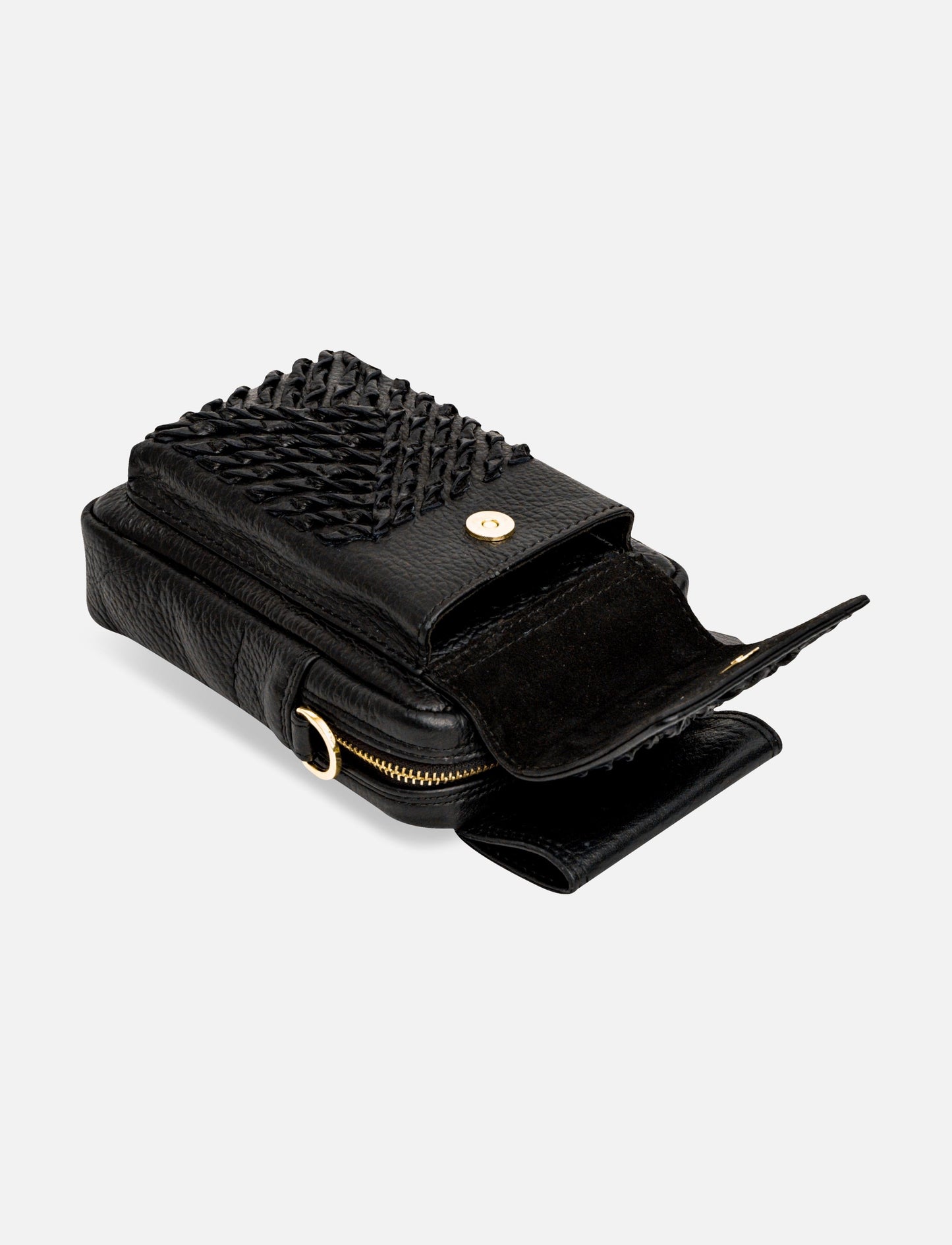 Black leather crossbody bag with woven flap, gold magnetic snap, and zipper pocket