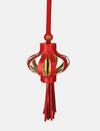 Red and gold hanging lantern charm ornament with tassels on white background