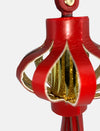 Close-up of red decorative Chinese lantern with gold glitter details on white background
