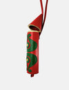 Red leather rocket-shaped hanging charm with green decorative patterns and gold accents